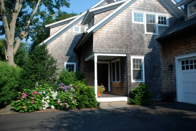 a front view of a house with a garden