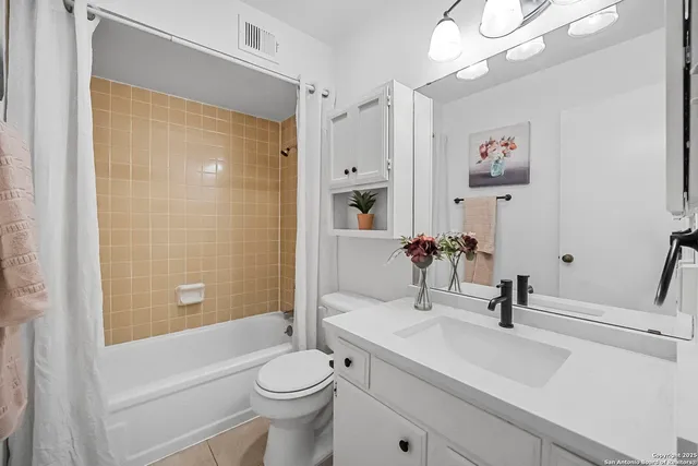 a bathroom with a bathtub and shower