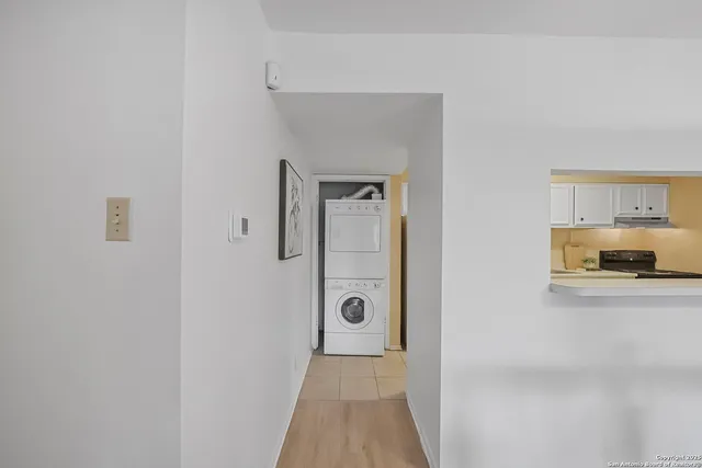 a view of a kitchen from the hallway