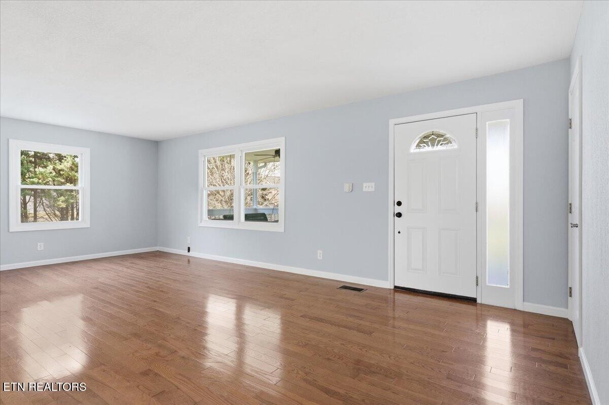 7709 Morris Road Knoxville, TN 37938 - Photo 11 of 52 an empty room with wooden floor and windows
