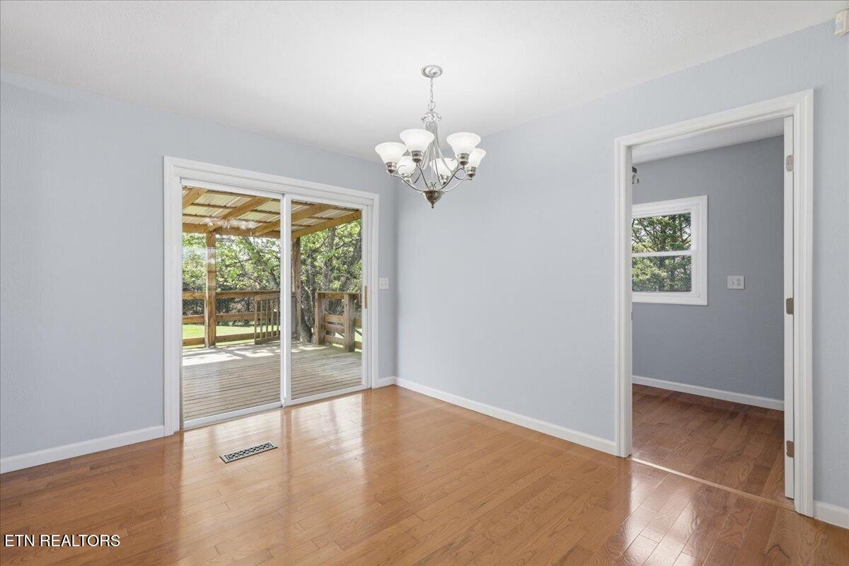 7709 Morris Road Knoxville, TN 37938 - Photo 20 of 52 a view of a livingroom with wooden floor and a large window