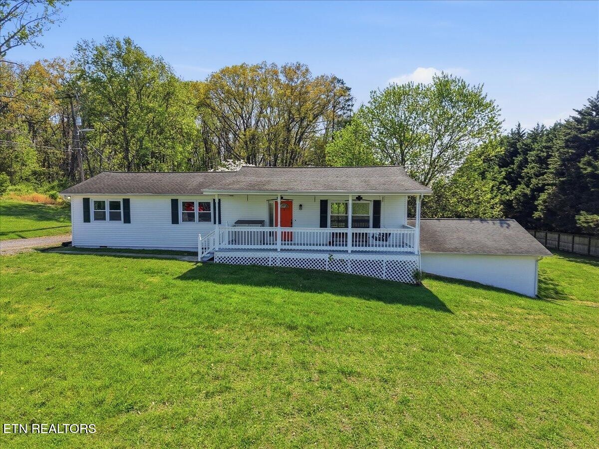 7709 Morris Road Knoxville, TN 37938 - Photo 2 of 52 a swimming pool with outdoor seating and yard