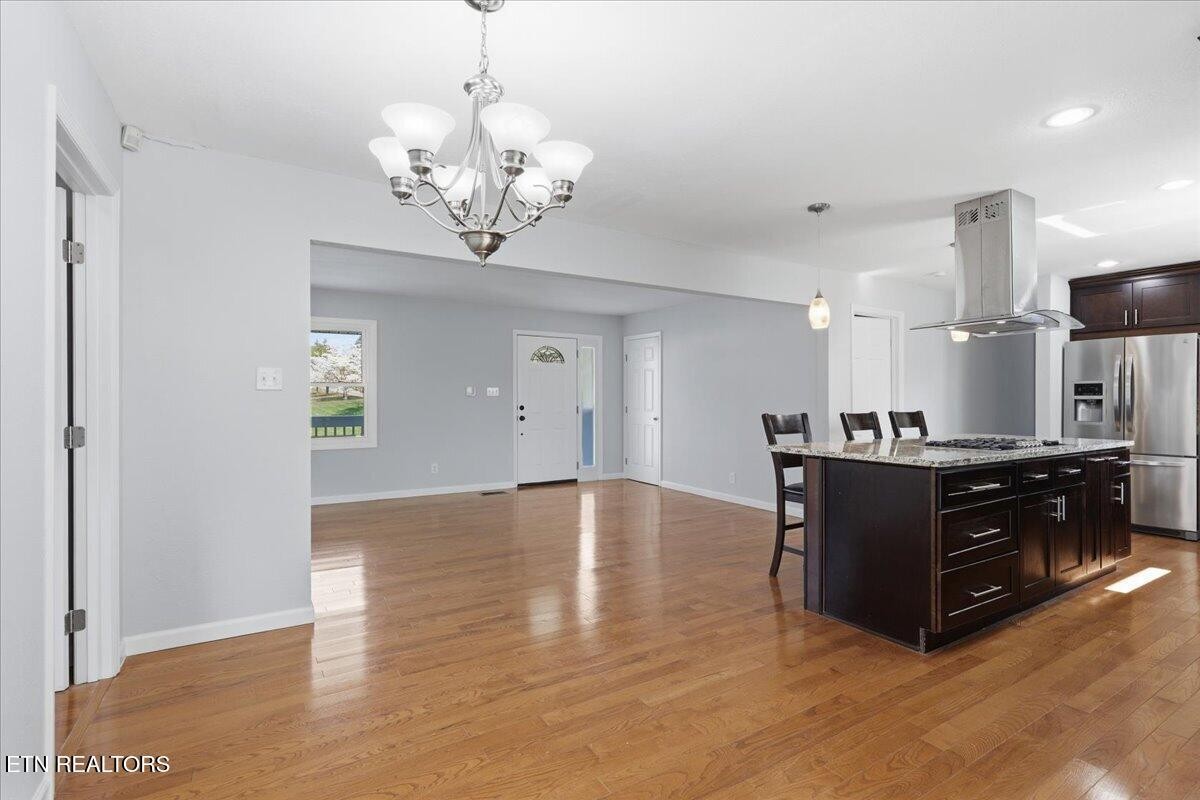 7709 Morris Road Knoxville, TN 37938 - Photo 21 of 52 a living room with stainless steel appliances granite countertop a couch and a chandelier