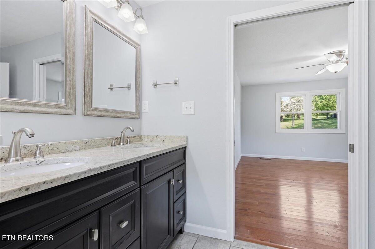 7709 Morris Road Knoxville, TN 37938 - Photo 27 of 52 a bathroom with a granite countertop sink a mirror and a