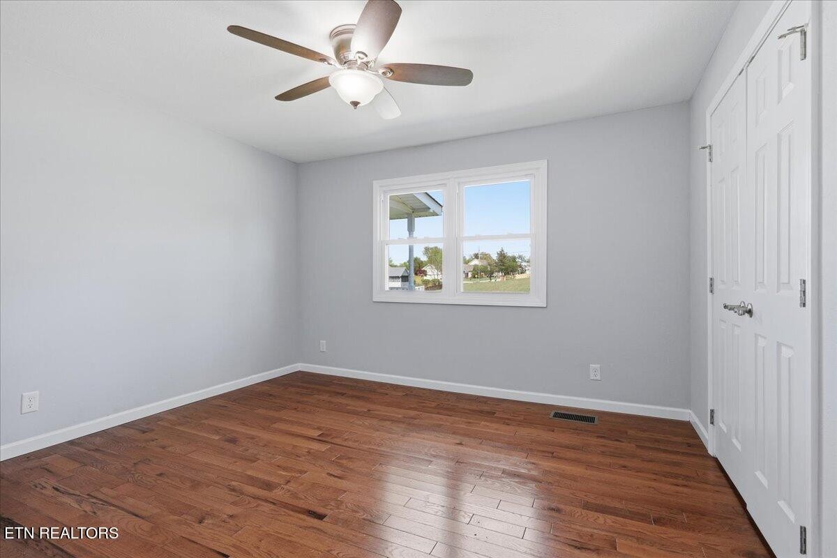 7709 Morris Road Knoxville, TN 37938 - Photo 31 of 52 an empty room with wooden floor and ceiling fan