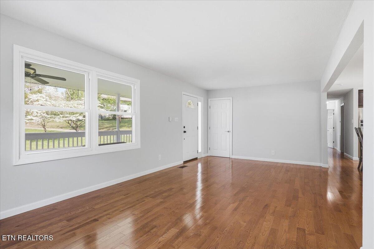 7709 Morris Road Knoxville, TN 37938 - Photo 9 of 52 a view of an empty room with wooden floor and a window
