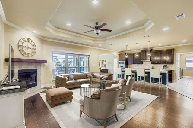 a living room with furniture a fireplace and a large window