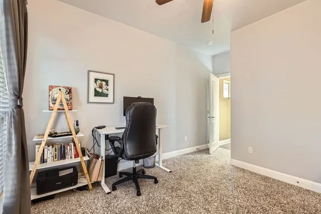 a living room with furniture ceiling fan and a rug