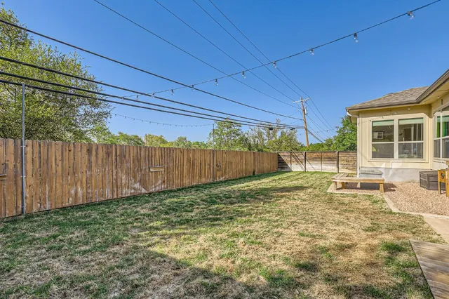 a view of a patio with table and chairs and wooden floor