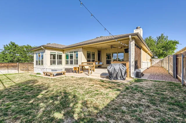a view of a backyard with wooden fence