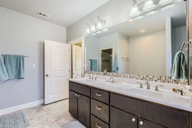 a bedroom with a bed a couch and a potted plant