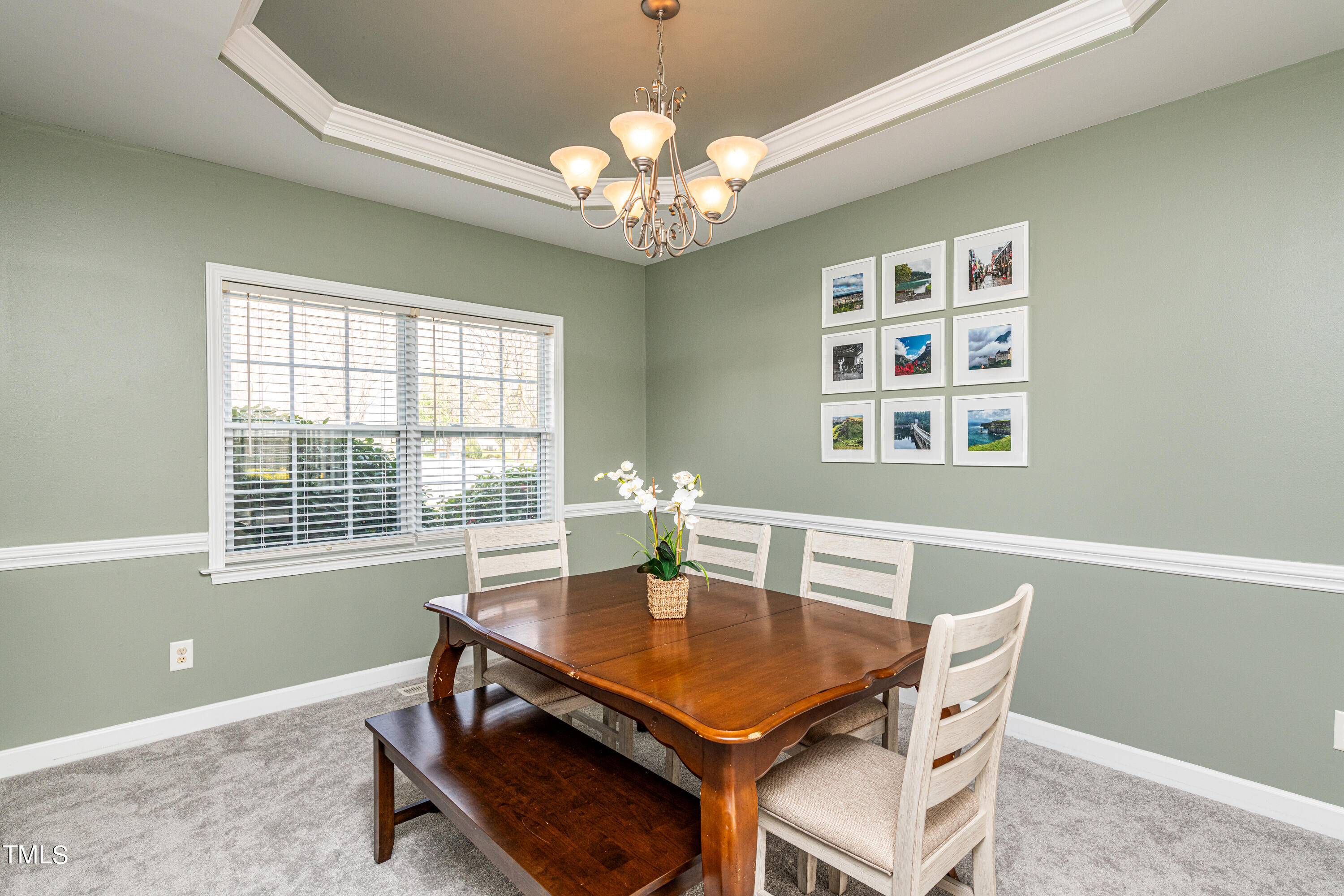 113 Sugarloaf Way Raleigh, NC 27603 - Photo 12 of 42 a view of a dining room with furniture and chandelier