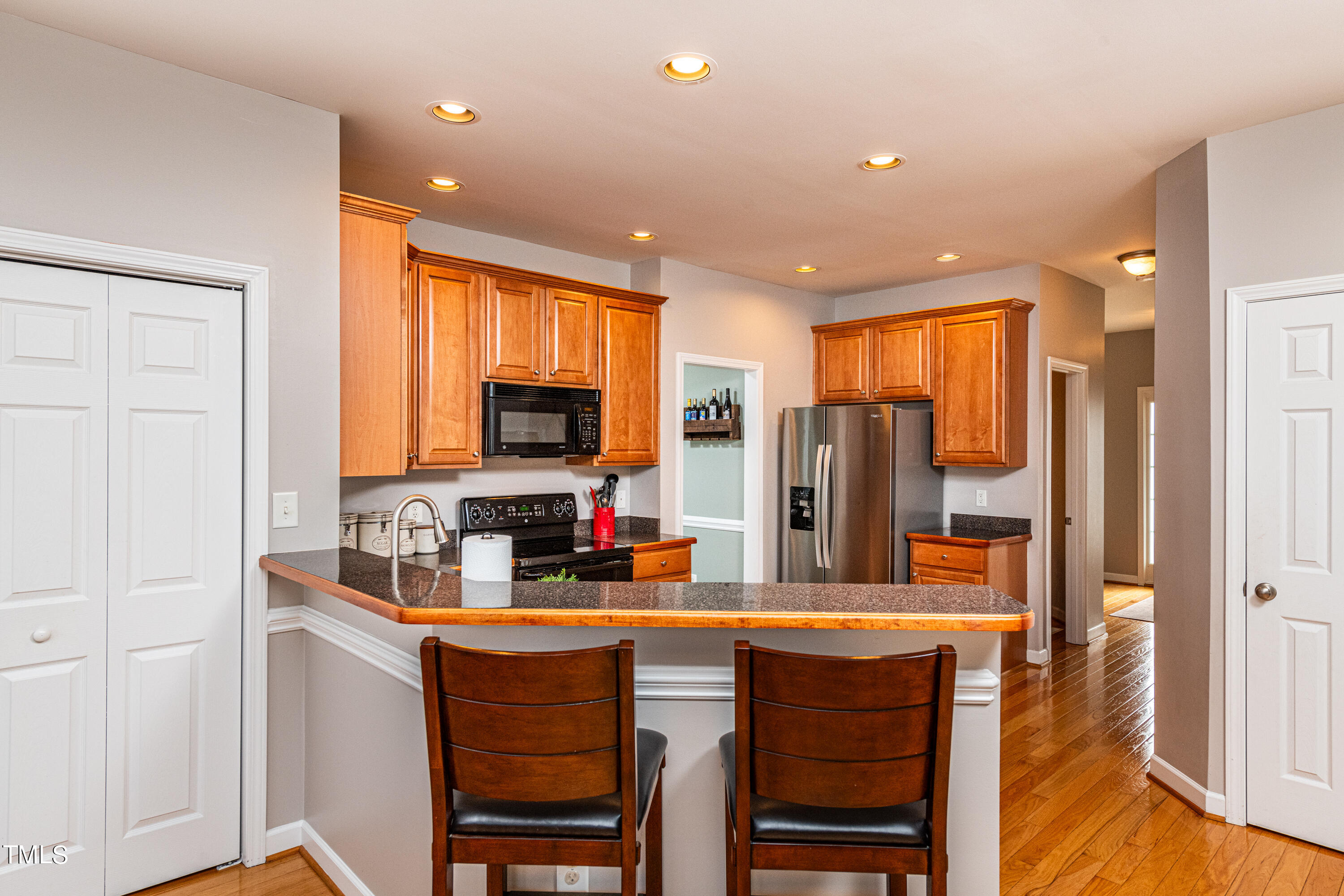 113 Sugarloaf Way Raleigh, NC 27603 - Photo 13 of 42 a kitchen with stainless steel appliances granite countertop a refrigerator and a stove top oven