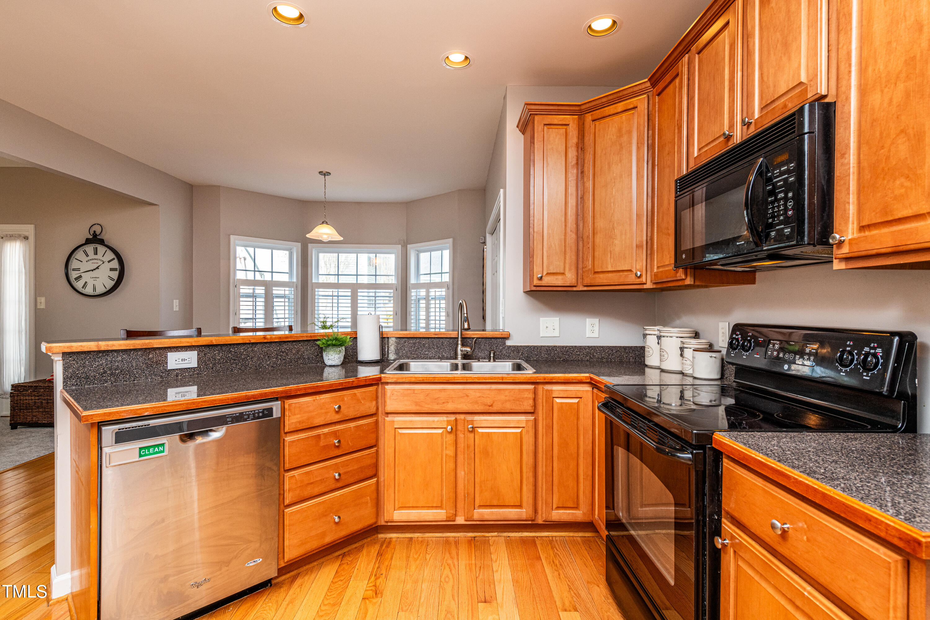 113 Sugarloaf Way Raleigh, NC 27603 - Photo 15 of 42 a kitchen with stainless steel appliances granite countertop a stove a sink and a microwave