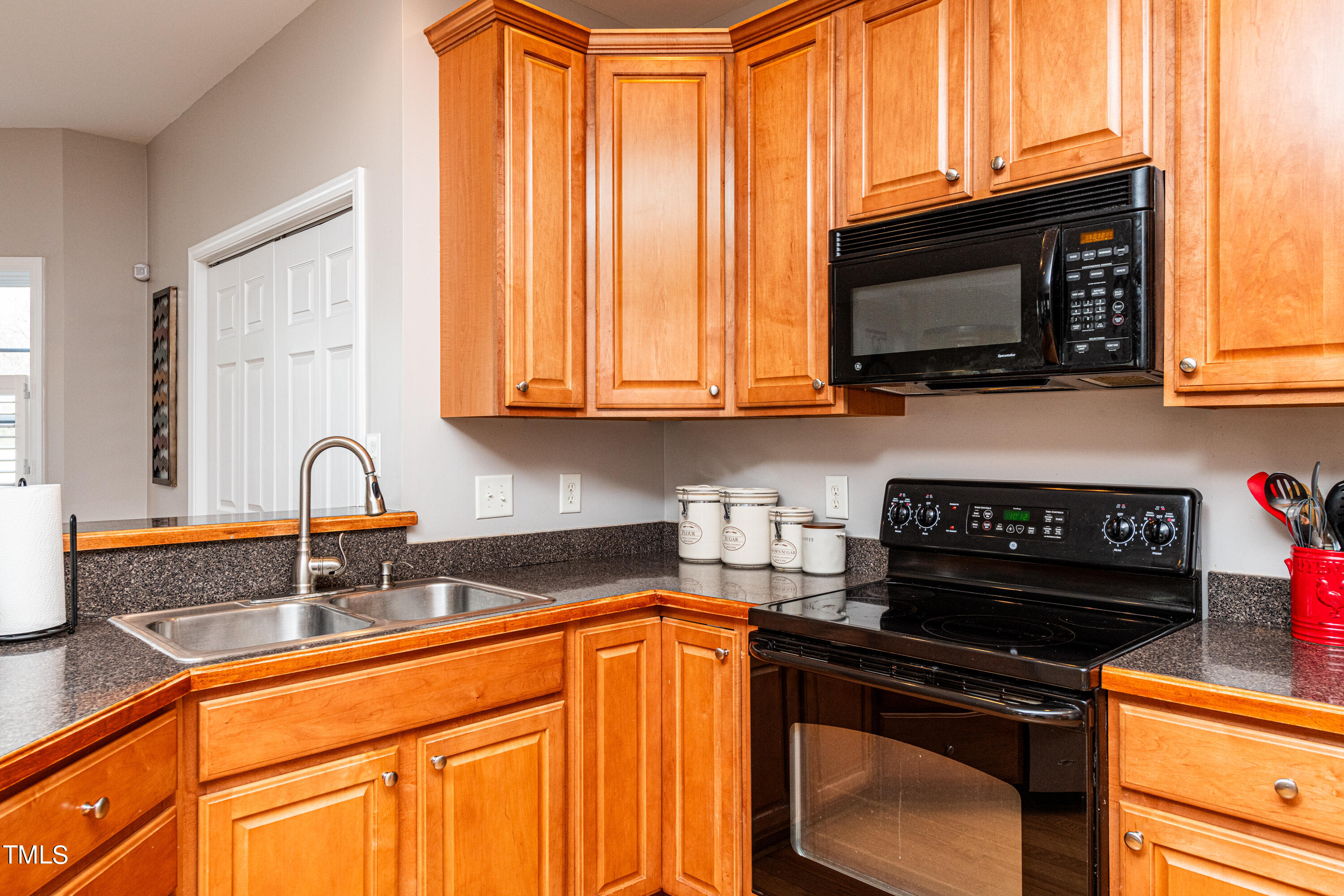 113 Sugarloaf Way Raleigh, NC 27603 - Photo 16 of 42 a kitchen with granite countertop a stove a sink and a microwave