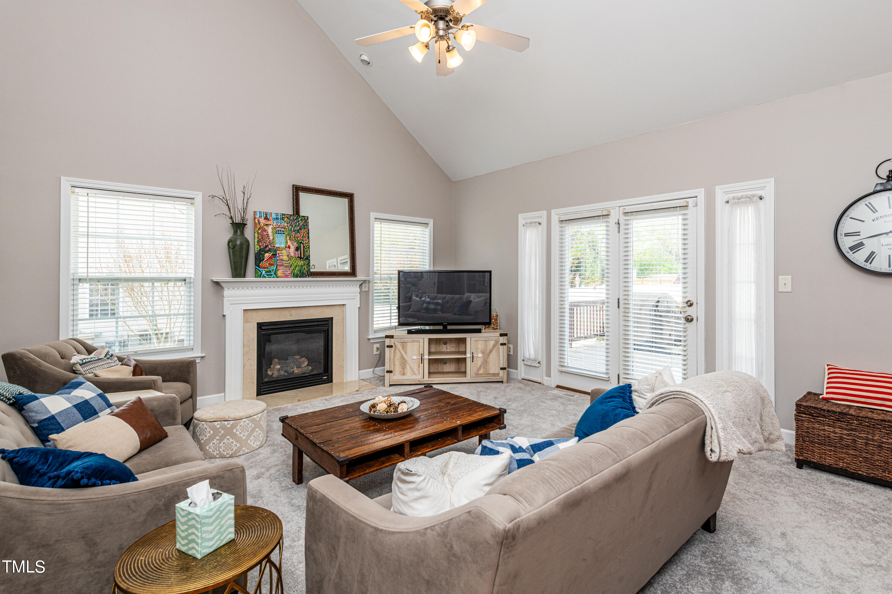 113 Sugarloaf Way Raleigh, NC 27603 - Photo 20 of 42 a living room with furniture a flat screen tv and a fireplace