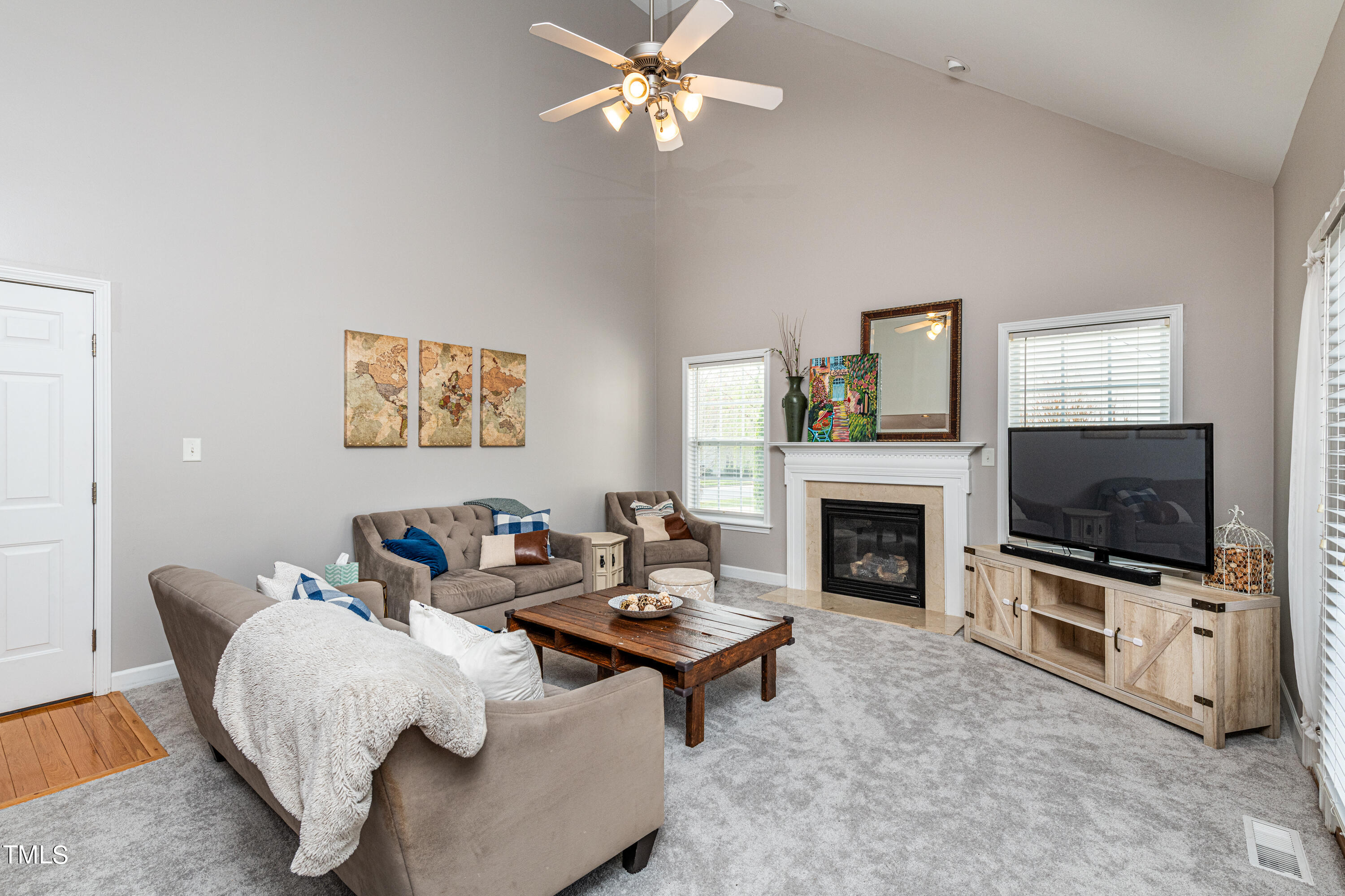 113 Sugarloaf Way Raleigh, NC 27603 - Photo 21 of 42 a living room with furniture a fireplace and a flat screen tv