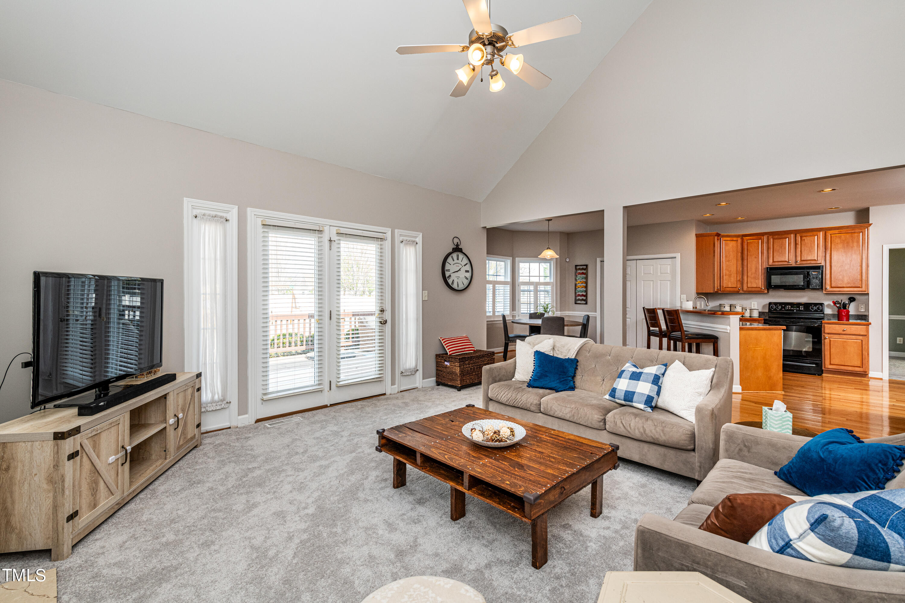 113 Sugarloaf Way Raleigh, NC 27603 - Photo 23 of 42 a living room with furniture a flat screen tv and kitchen view