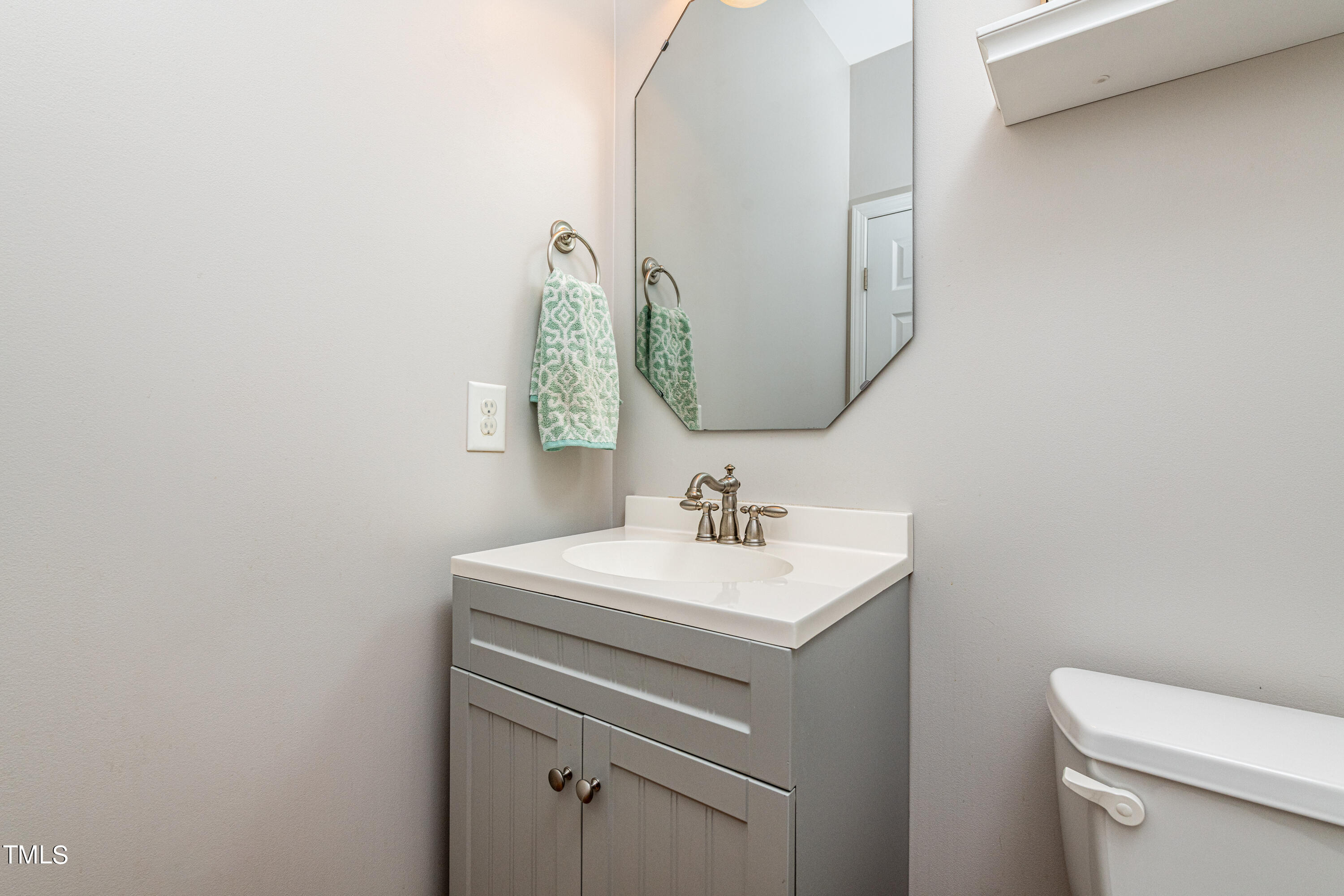 113 Sugarloaf Way Raleigh, NC 27603 - Photo 24 of 42 a bathroom with a sink a toilet and mirror