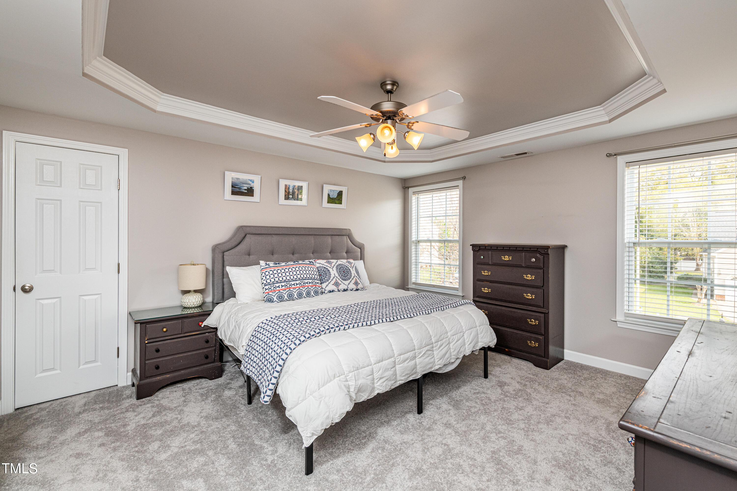 113 Sugarloaf Way Raleigh, NC 27603 - Photo 25 of 42 a bedroom with a bed and a chandelier