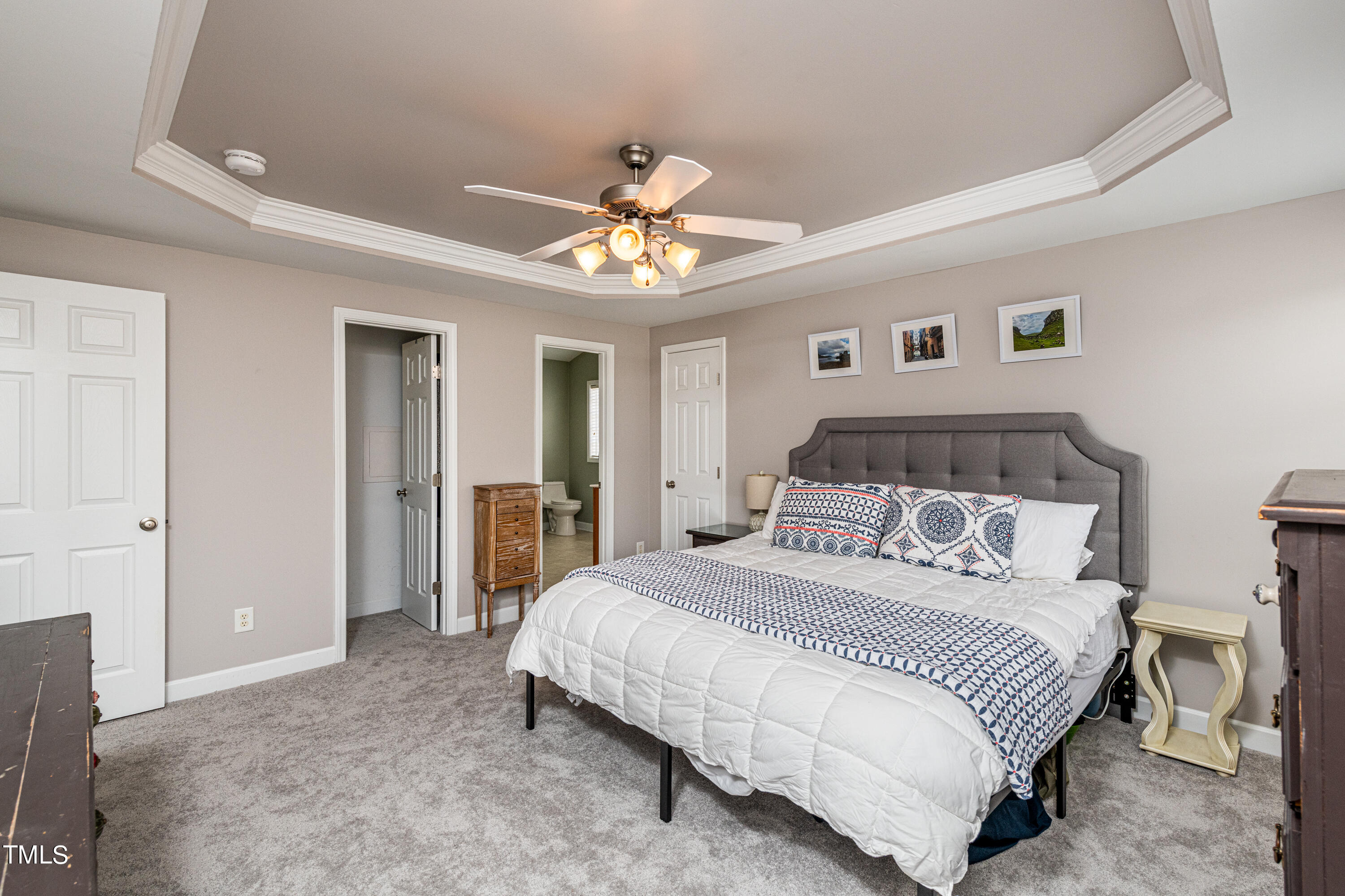 113 Sugarloaf Way Raleigh, NC 27603 - Photo 26 of 42 a bedroom with a bed and a chandelier