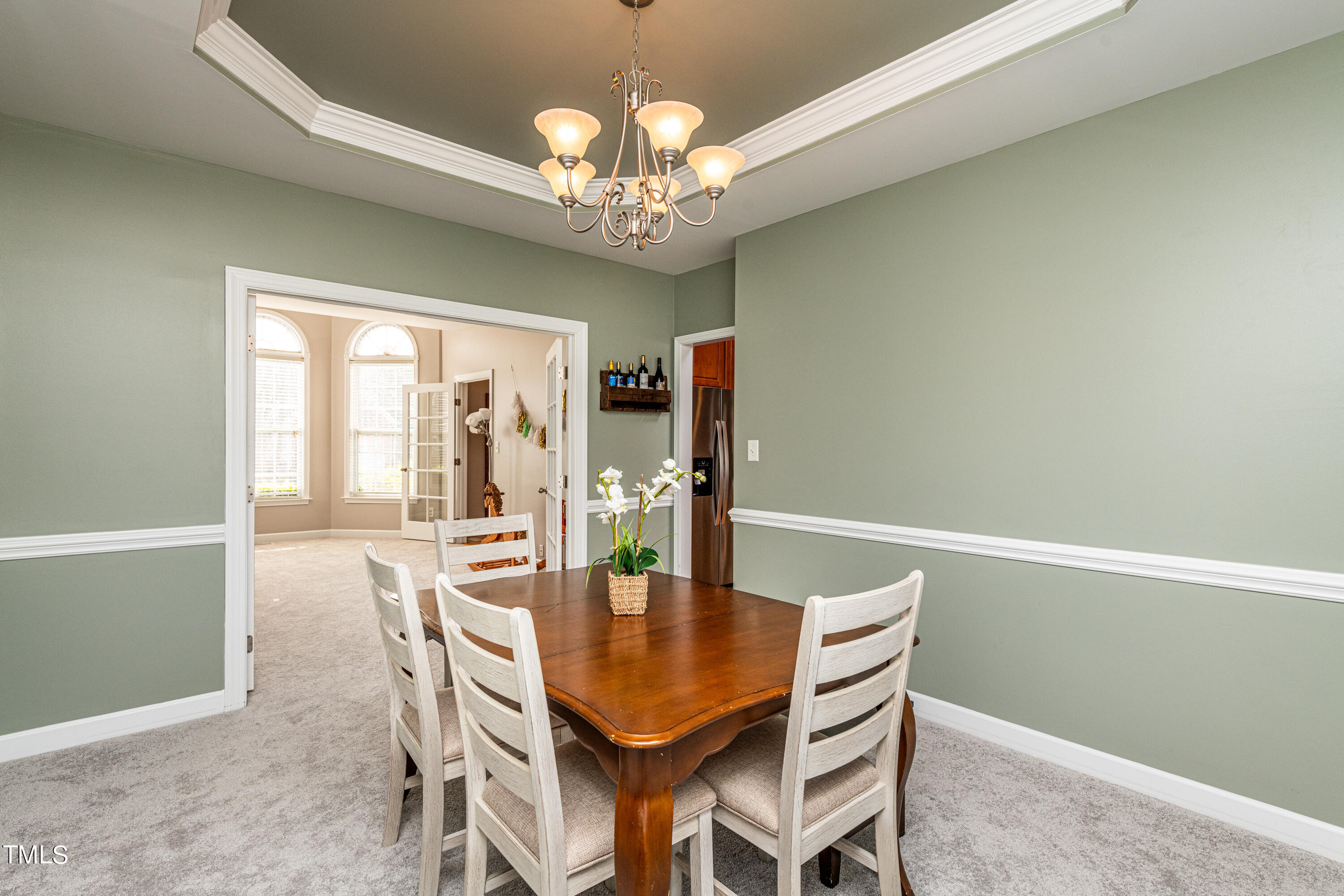 113 Sugarloaf Way Raleigh, NC 27603 - Photo 10 of 42 a dining room with furniture a chandelier and wooden floor