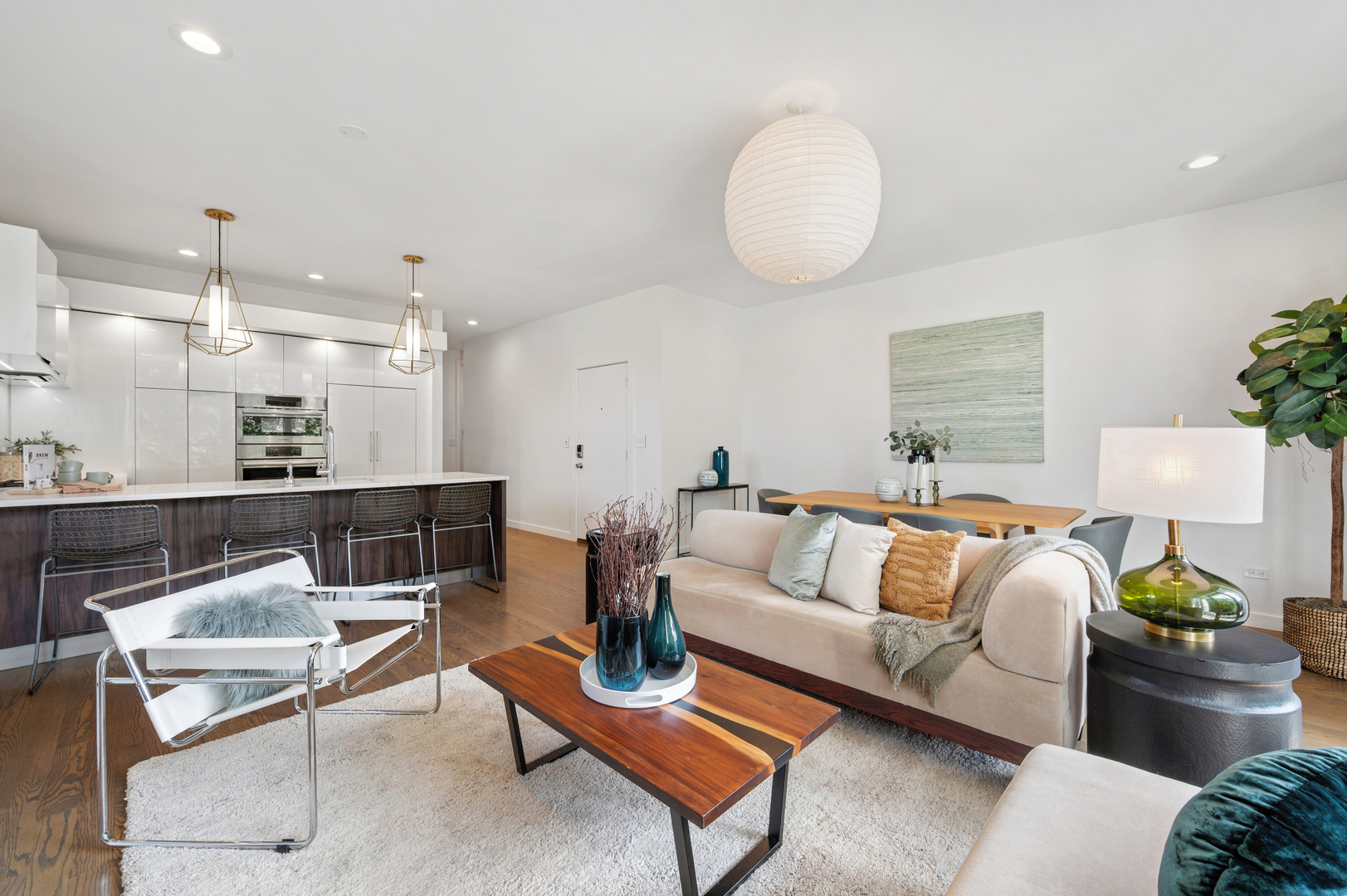 2237 North Hoyne Avenue, Unit 3N Chicago, IL 60647 - Photo 4 of 22 a living room with furniture a rug and a chandelier