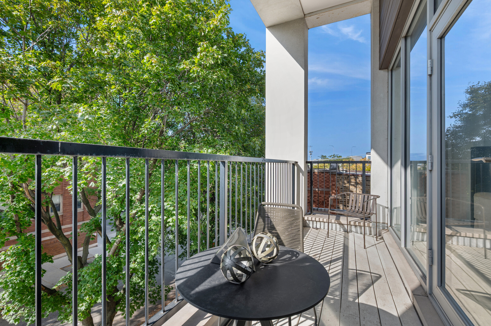 2237 North Hoyne Avenue, Unit 3N Chicago, IL 60647 - Photo 8 of 22 a view of a balcony with chairs and wooden floor