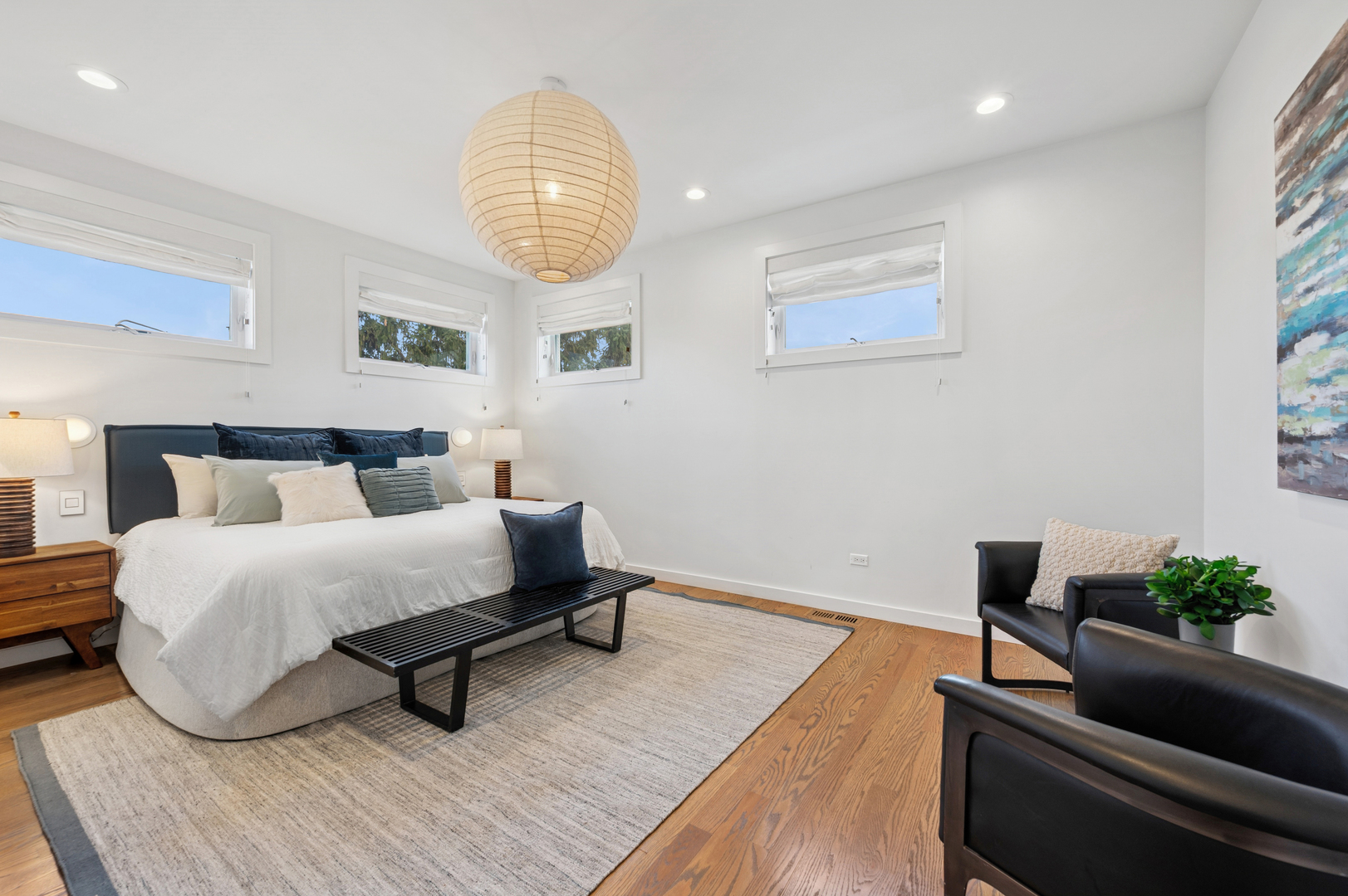 2237 North Hoyne Avenue, Unit 3N Chicago, IL 60647 - Photo 9 of 22 a spacious bedroom with a bed and a chandelier