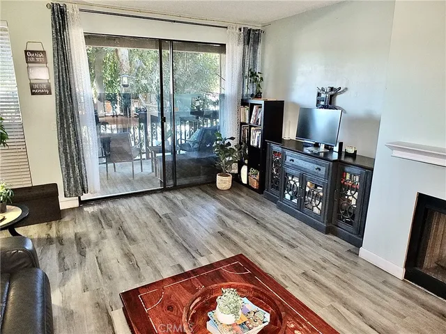 a view of balcony with wooden floor and outdoor seating