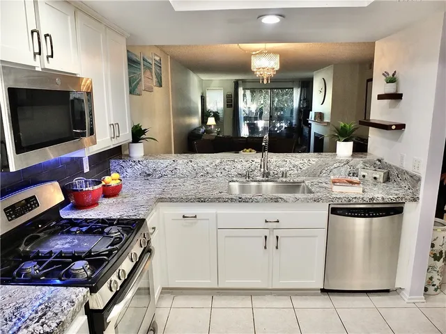 a kitchen view with living room couch and a large mirror