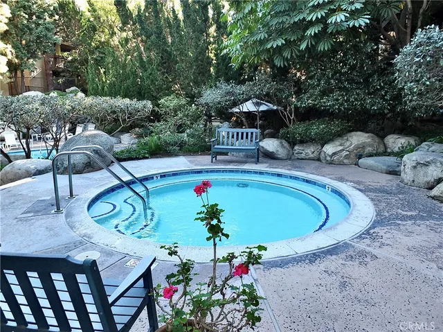 a view of a swimming pool with a yard and sitting area