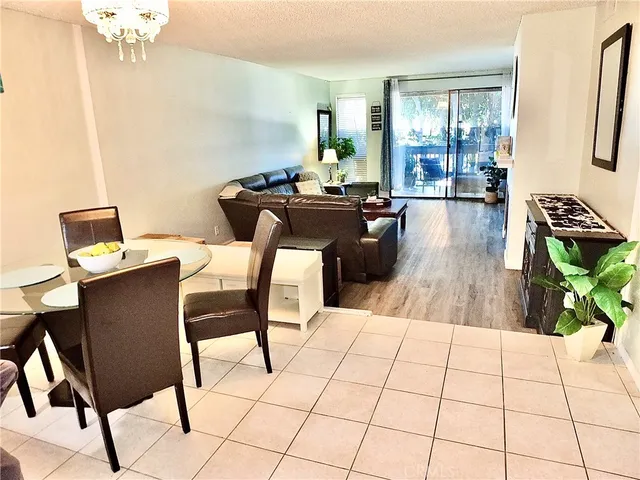 a kitchen with stainless steel appliances kitchen island granite countertop a sink and a refrigerator