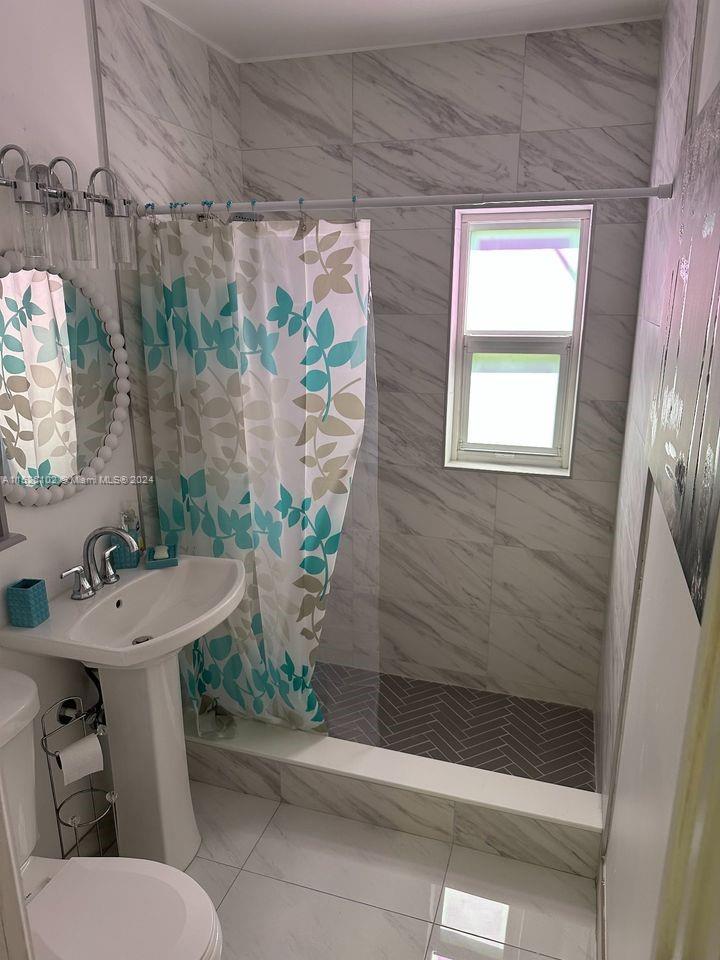 14821 Pierce Street Miami, FL 33176 - Photo 2 of 5 a bathroom with a sink toilet and shower