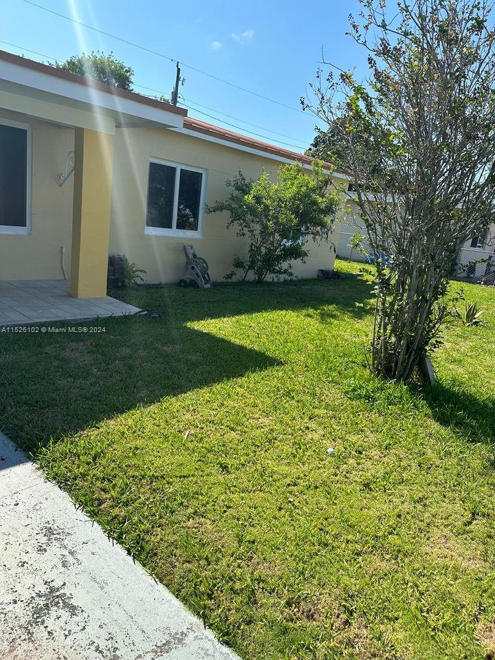 14821 Pierce Street Miami, FL 33176 - Photo 5 of 5 a view of backyard with potted plants and large tree