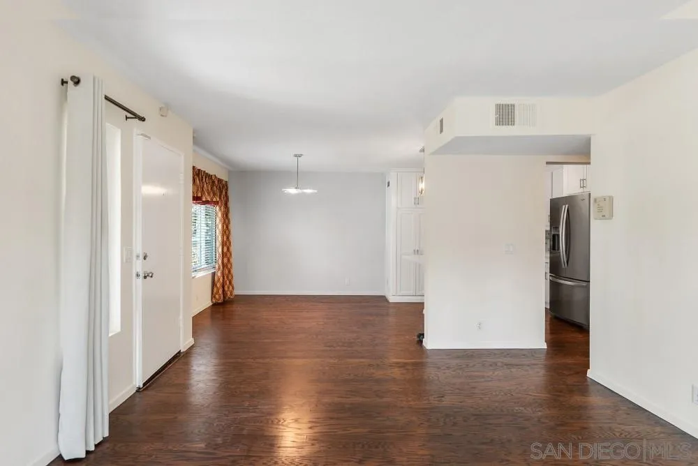 219 Diamond Way, Unit 115 Vista, CA 92083 - Photo 11 of 36 a view of a kitchen with a refrigerator and wooden floor