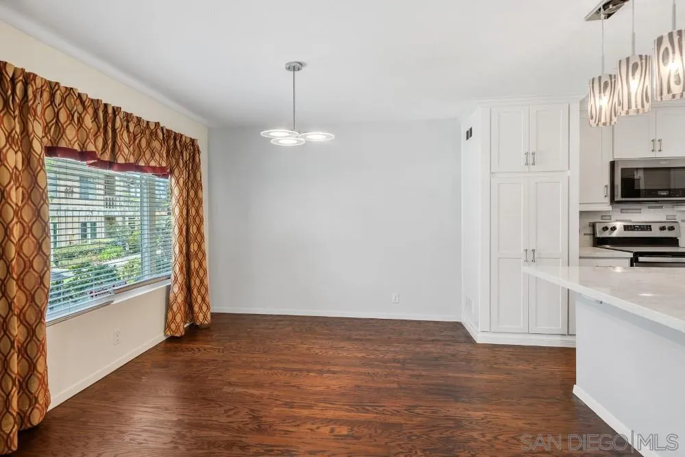 219 Diamond Way, Unit 115 Vista, CA 92083 - Photo 12 of 36 a view of empty room with wooden floor and fan