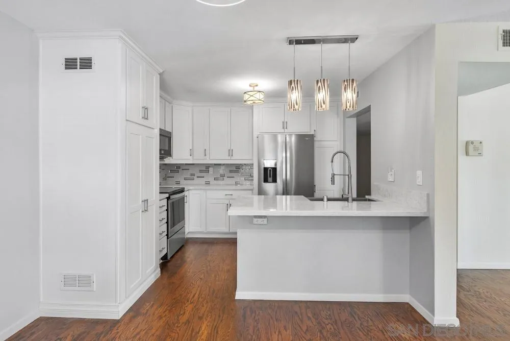 219 Diamond Way, Unit 115 Vista, CA 92083 - Photo 14 of 36 a view of a kitchen with a sink stainless steel appliances and cabinets