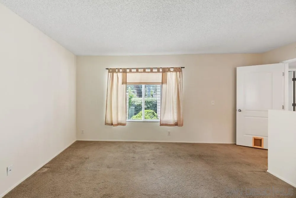 219 Diamond Way, Unit 115 Vista, CA 92083 - Photo 24 of 36 a view of an empty room with a window