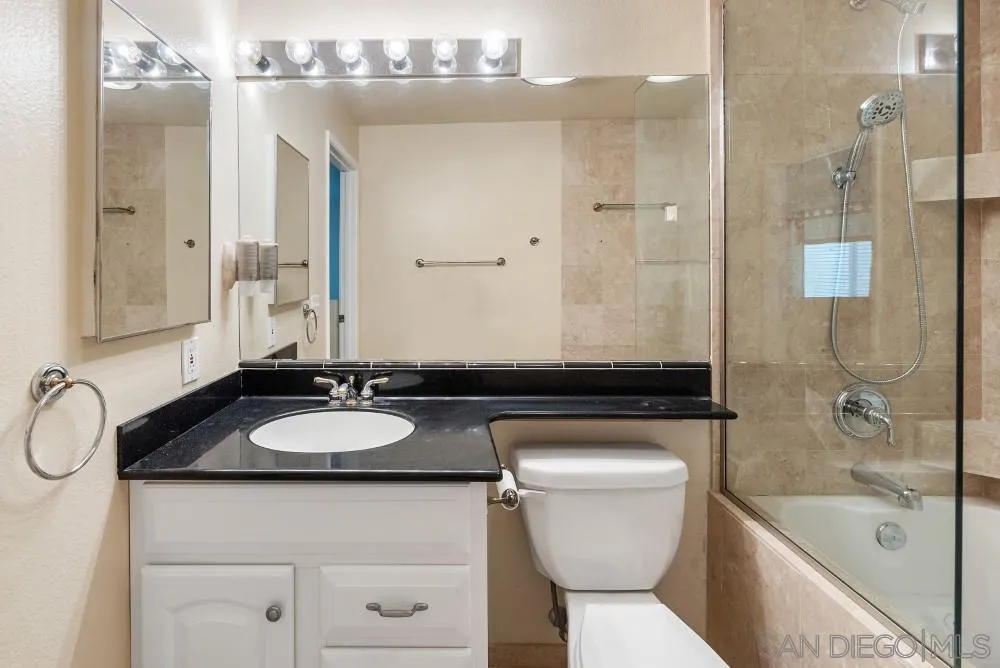 219 Diamond Way, Unit 115 Vista, CA 92083 - Photo 26 of 36 a bathroom with a granite countertop sink toilet and shower