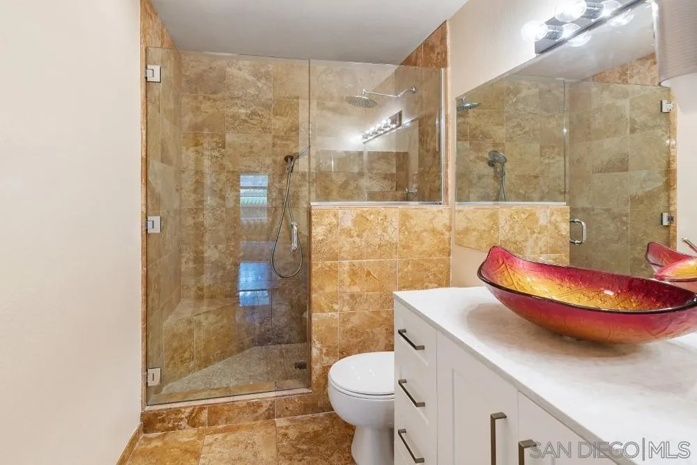 219 Diamond Way, Unit 115 Vista, CA 92083 - Photo 30 of 36 a bathroom with a sink toilet and shower