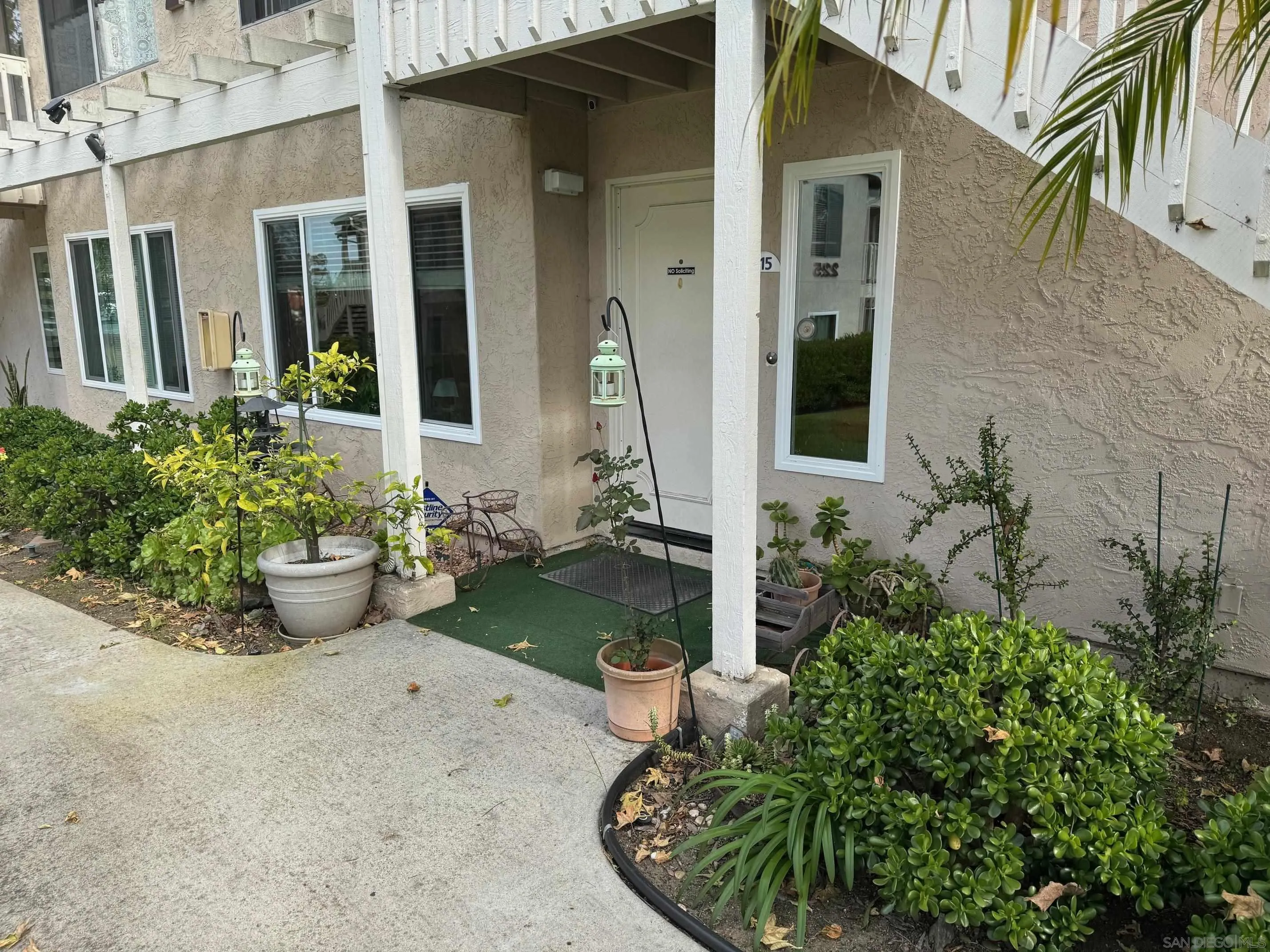 219 Diamond Way, Unit 115 Vista, CA 92083 - Photo 35 of 36 front view of a house with potted plants