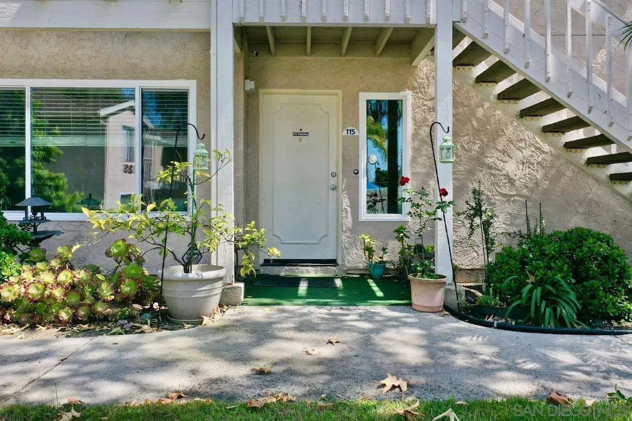 219 Diamond Way, Unit 115 Vista, CA 92083 - Photo 36 of 36 a front view of a house with a yard