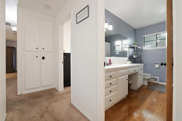 a bathroom with a sink a large mirror and a toilet