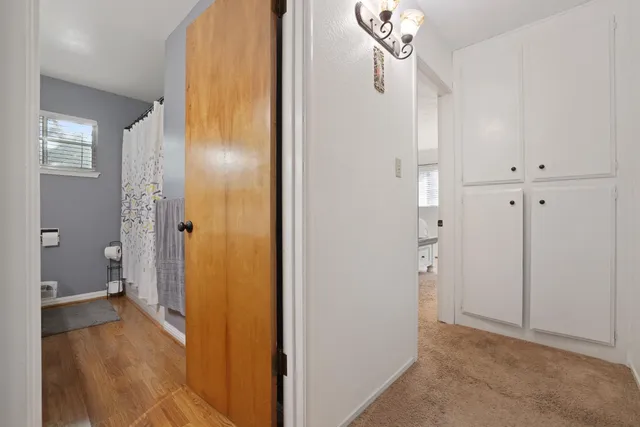 a spacious bedroom with a bed and a chandelier