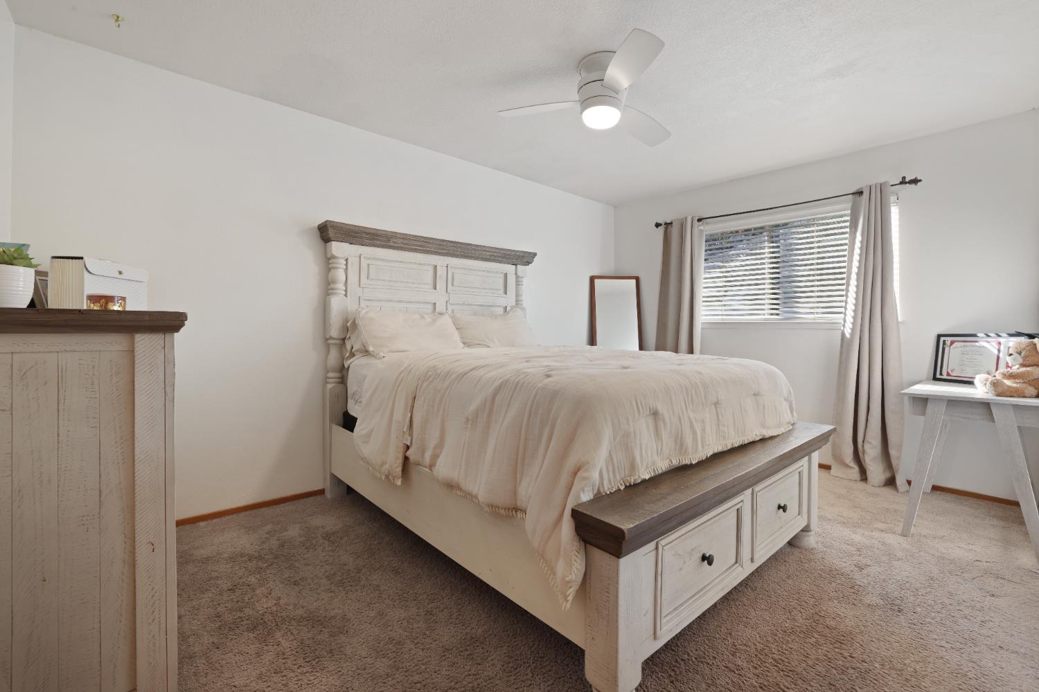 1608 Kruger Drive Modesto, CA 95355 - Photo 17 of 35 a spacious bedroom with a bed and a chandelier