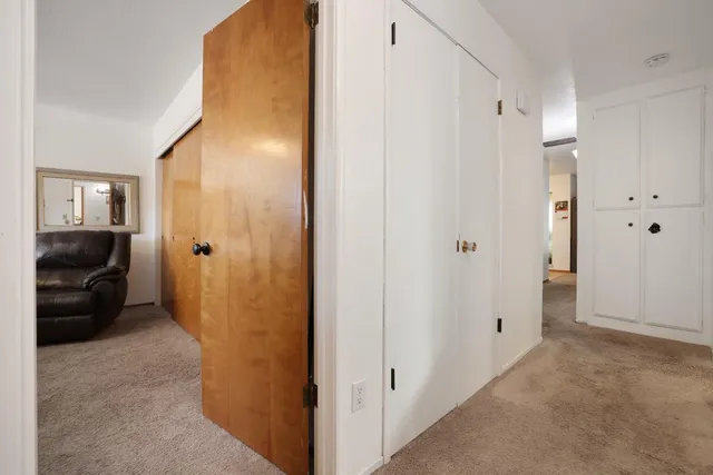 a bedroom with a bed couch and a window