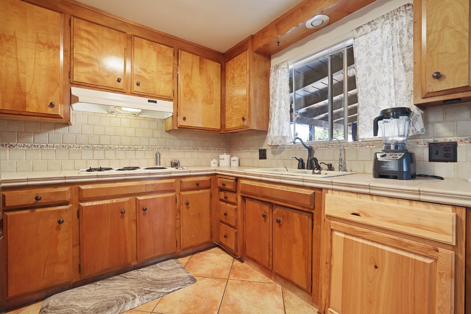 1608 Kruger Drive Modesto, CA 95355 - Photo 24 of 35 a kitchen with granite countertop sink cabinets and stainless steel appliances