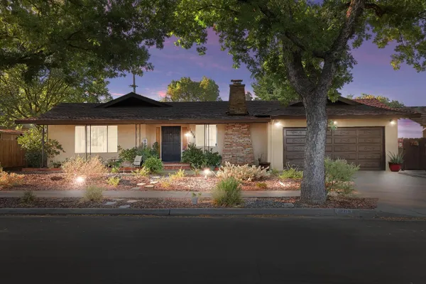 a front view of house with yard outdoor seating and green space
