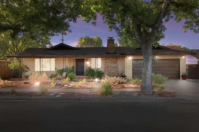 a front view of house with yard outdoor seating and green space